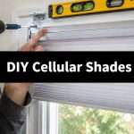 Close-up of a hand drilling a screw into a window frame for cellular shade installation; a level sits above.