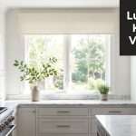 valances-for-the-kitchen-window-treatment | Drapery Company Bright white kitchen with marble countertops and a bold black sign reading 'Luxurious Kitchen Valances' in the upper right.