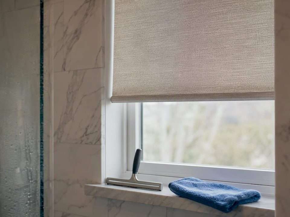 1787000561696_Bathroom-window-with-roller-shade-installing | Drapery Company Bathroom window with roller shade installing