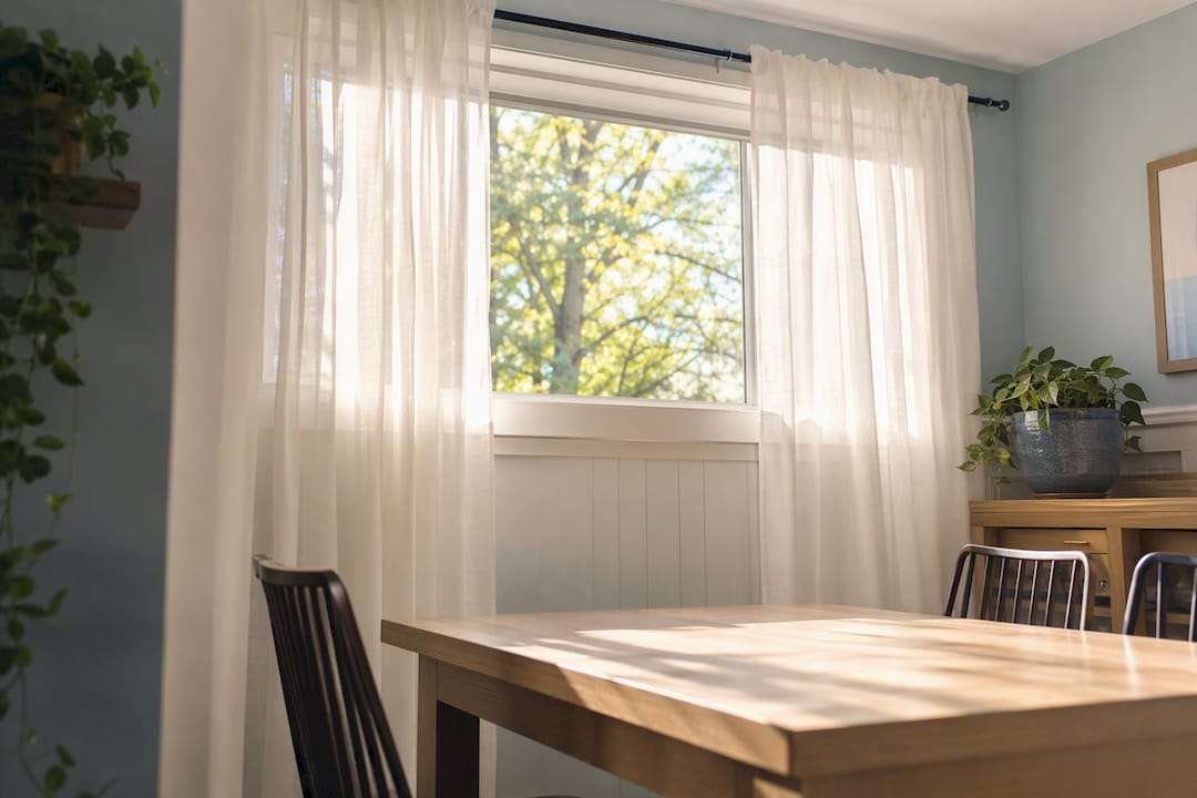 Sheer curtains softly diffusing light on transom window