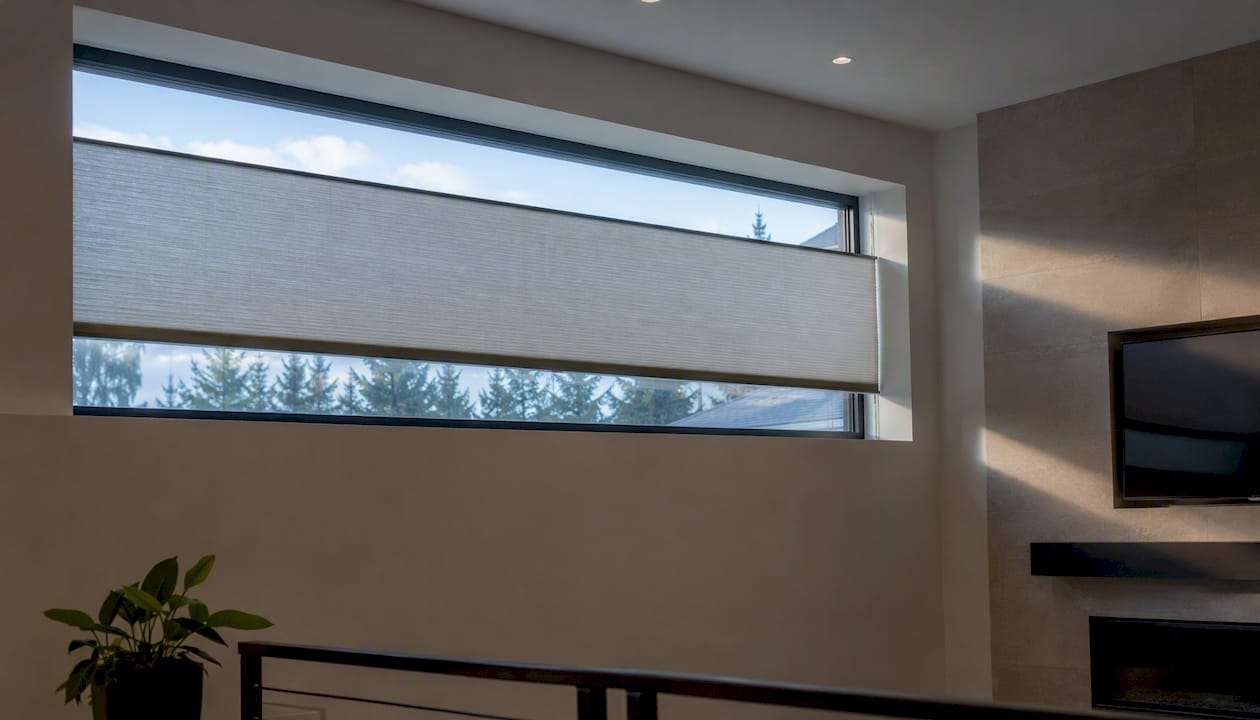 Motorized cellular shade installed on transom window