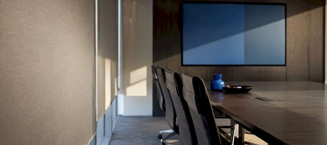 Conference room shade edge beside presentation display