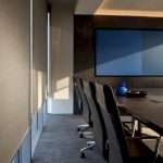 Conference room shade edge beside presentation display