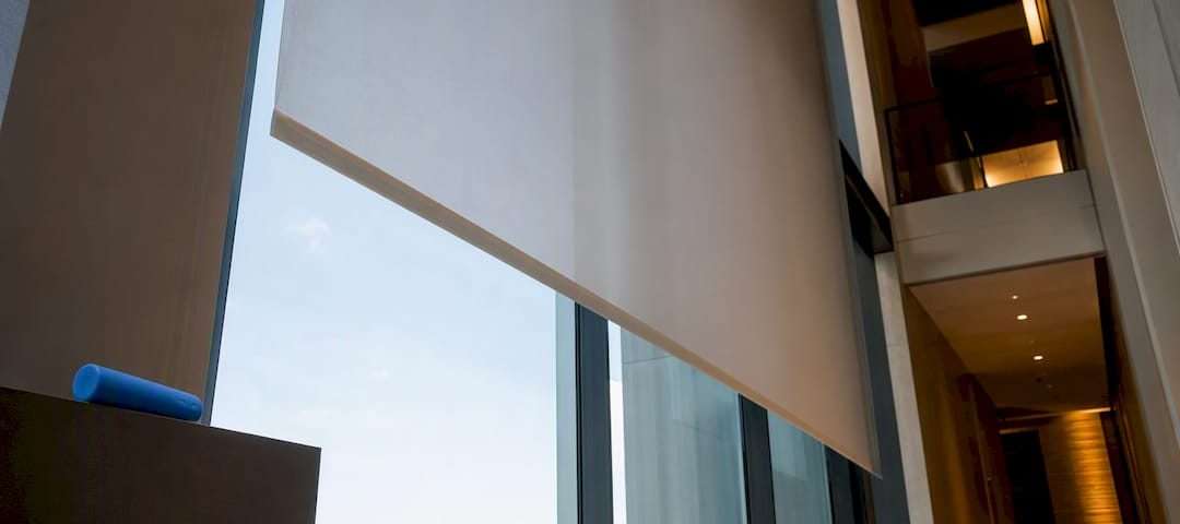 Partial motorized shade in double-height atrium