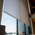 Partial motorized shade in double-height atrium