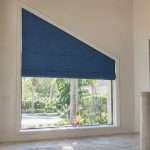 Blue shade fitted to an angled foyer window