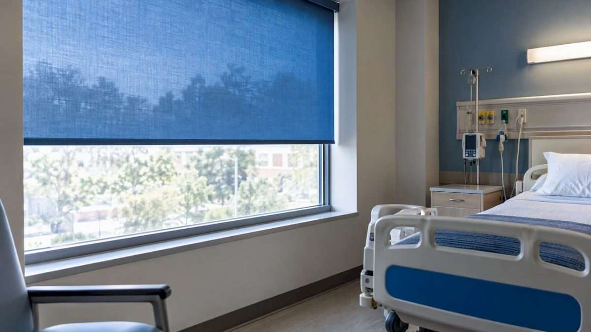 Blue window shade screening a hospital room