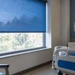 Blue window shade screening a hospital room