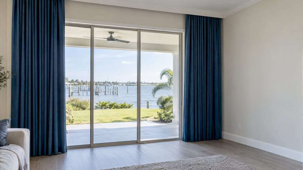 Custom blue drapery framing a Tampa Bay sliding door