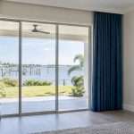 Custom blue drapery framing a Tampa Bay sliding door