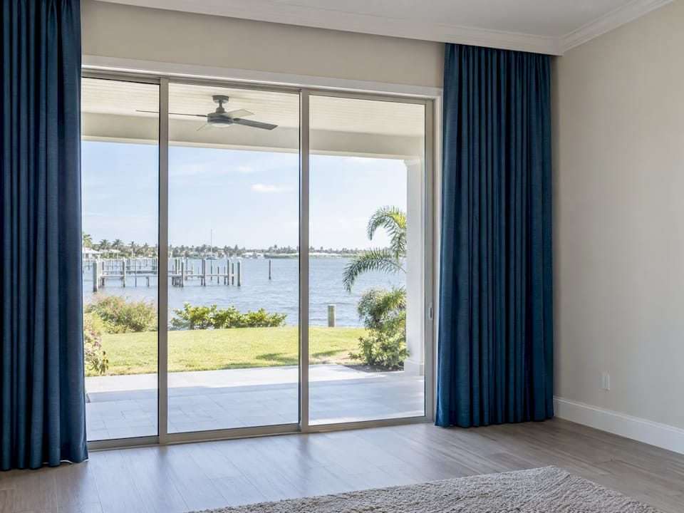 Custom blue drapery framing a Tampa Bay sliding door