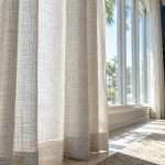 Woven drapery filtering bright Tampa sunroom light