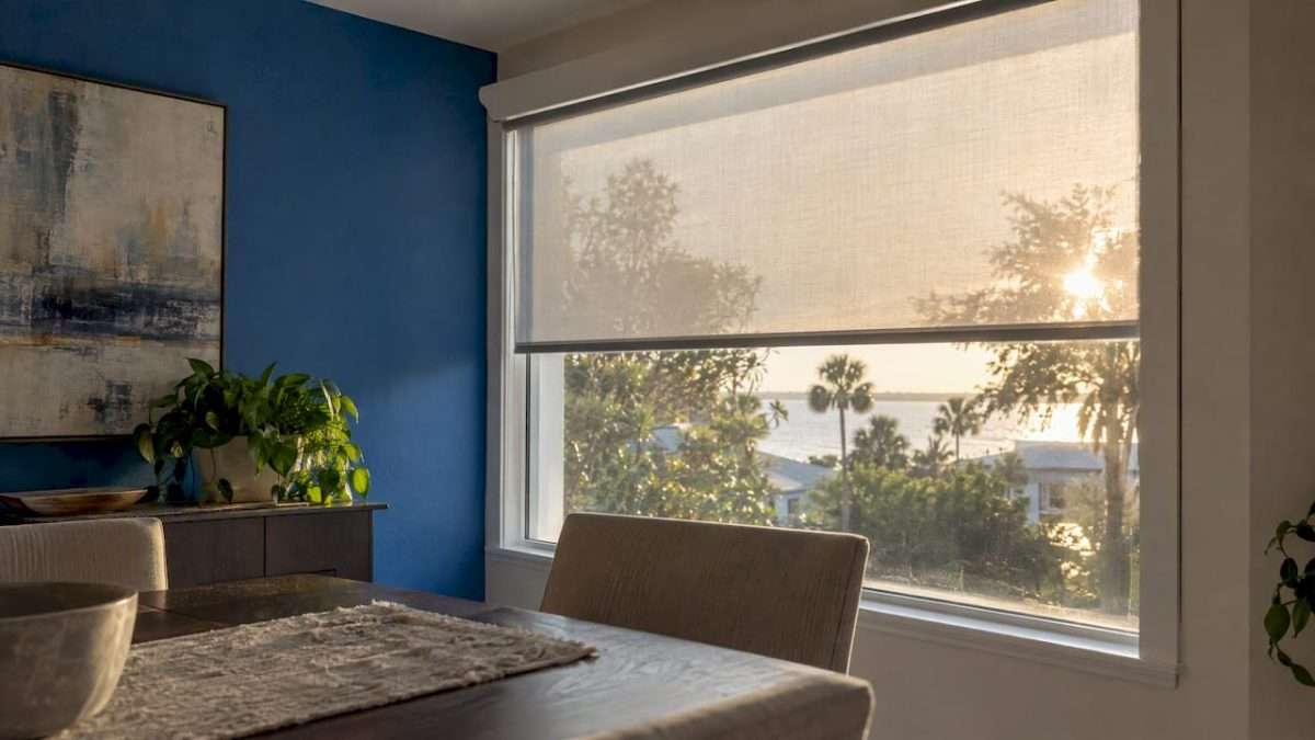 Solar shade softens late sun at west-facing window