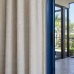 Linen-look drapery beside a screened lanai door